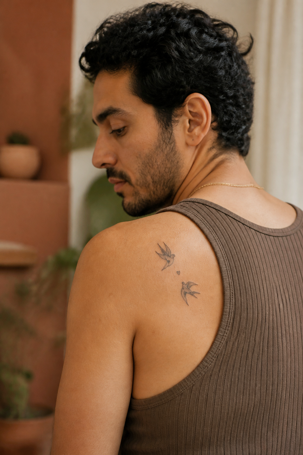 Twin Swallows tattoo shown from a distinct editorial angle