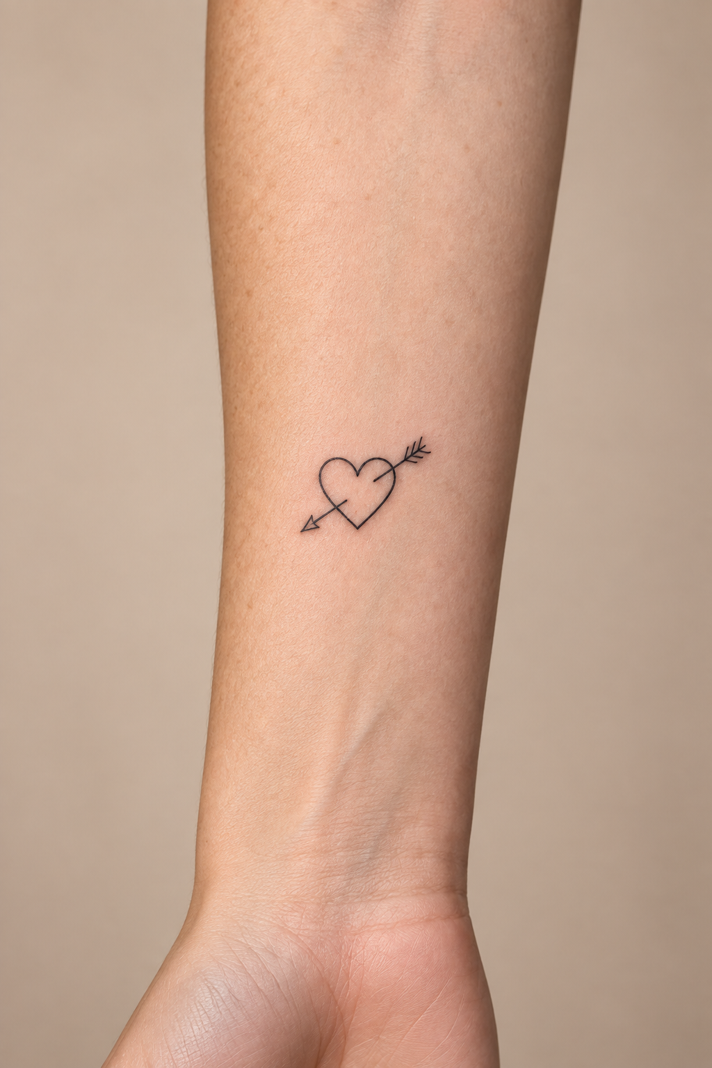 Minimalist Heart with Arrow Through It small heart tattoo idea