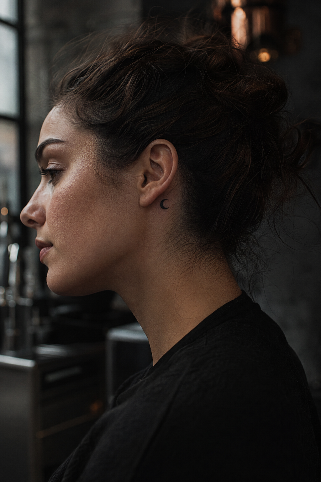Black and white small tattoos for women with a crescent behind the ear