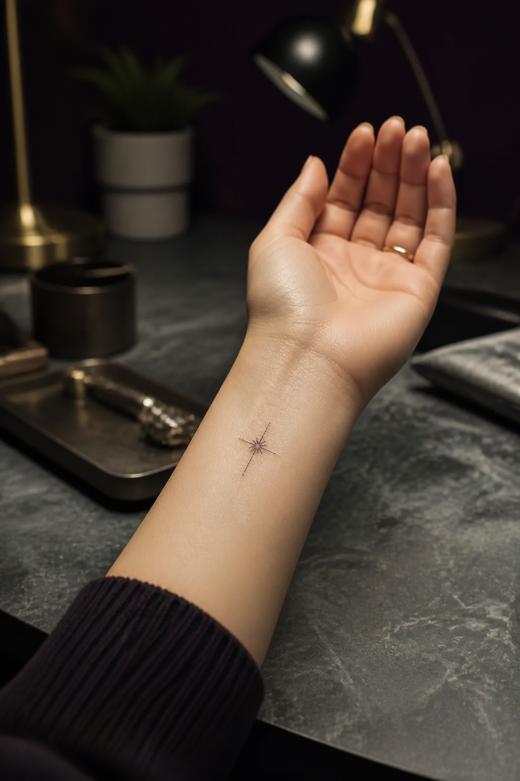 Tiny radiant cross tattoo with a light burst on the wrist