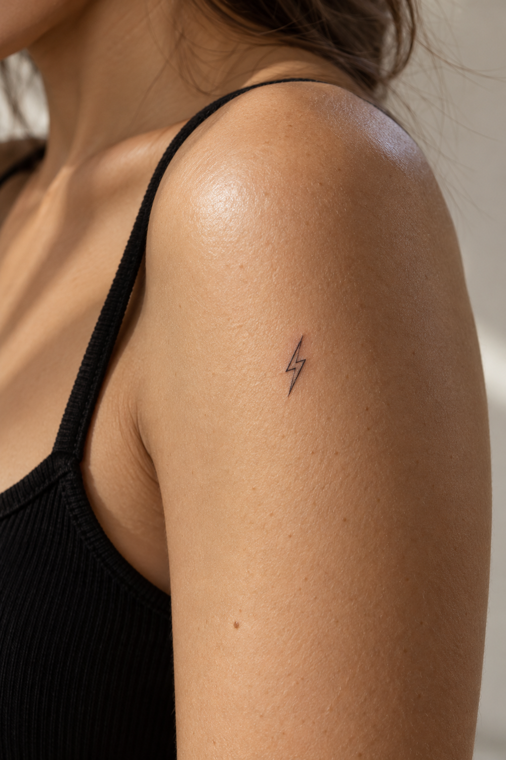 Tiny Meaningful Tattoo Ideas For Women featuring a tiny lightning bolt symbol
