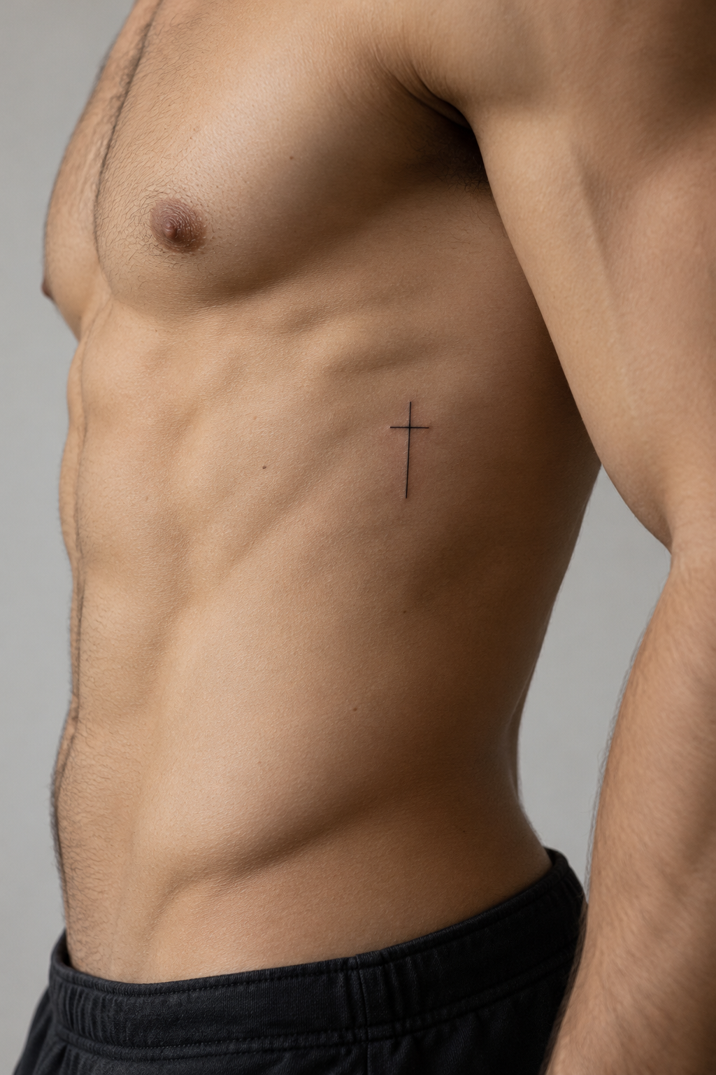 minimal Christian tattoos for men: small cross with text on the ribs