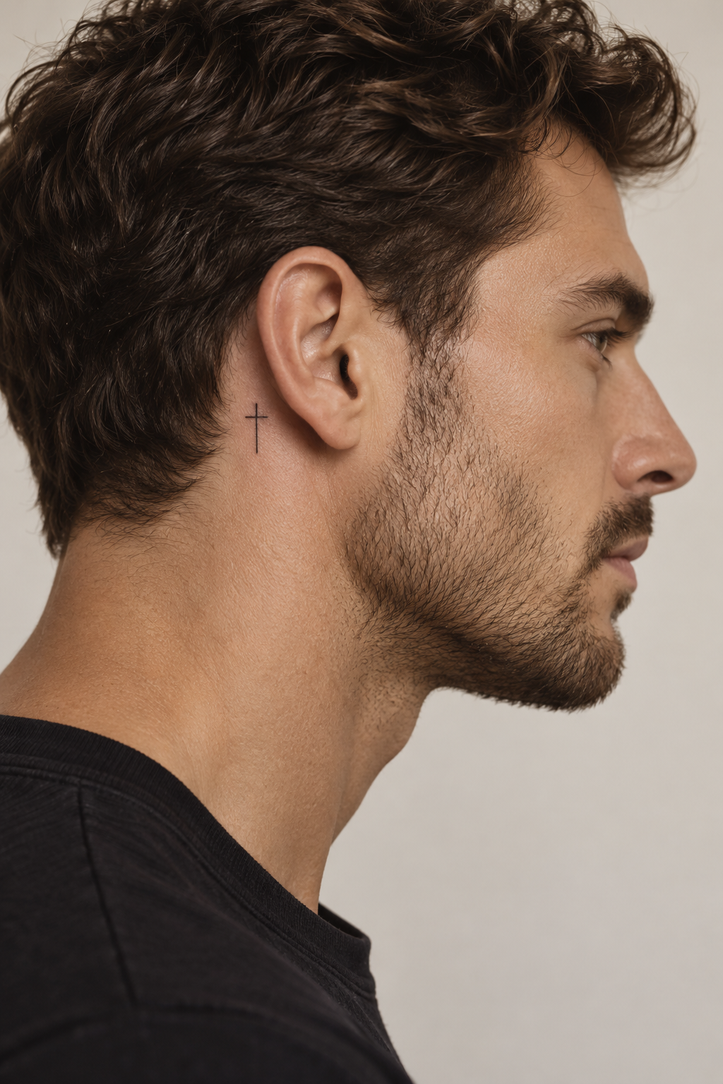minimal Christian tattoos for men: small cross behind the ear